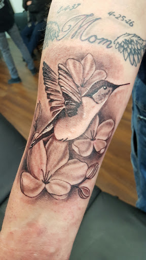 Explore flower tattoo sleeve ideas, creative tattoo ideas in Roscoe, available at Elevated Ink Tattoo