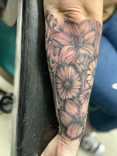 Find flower thigh tattoo ideas for your next unique tattoo in Lawton at Impact Ink Tattoo Studios
