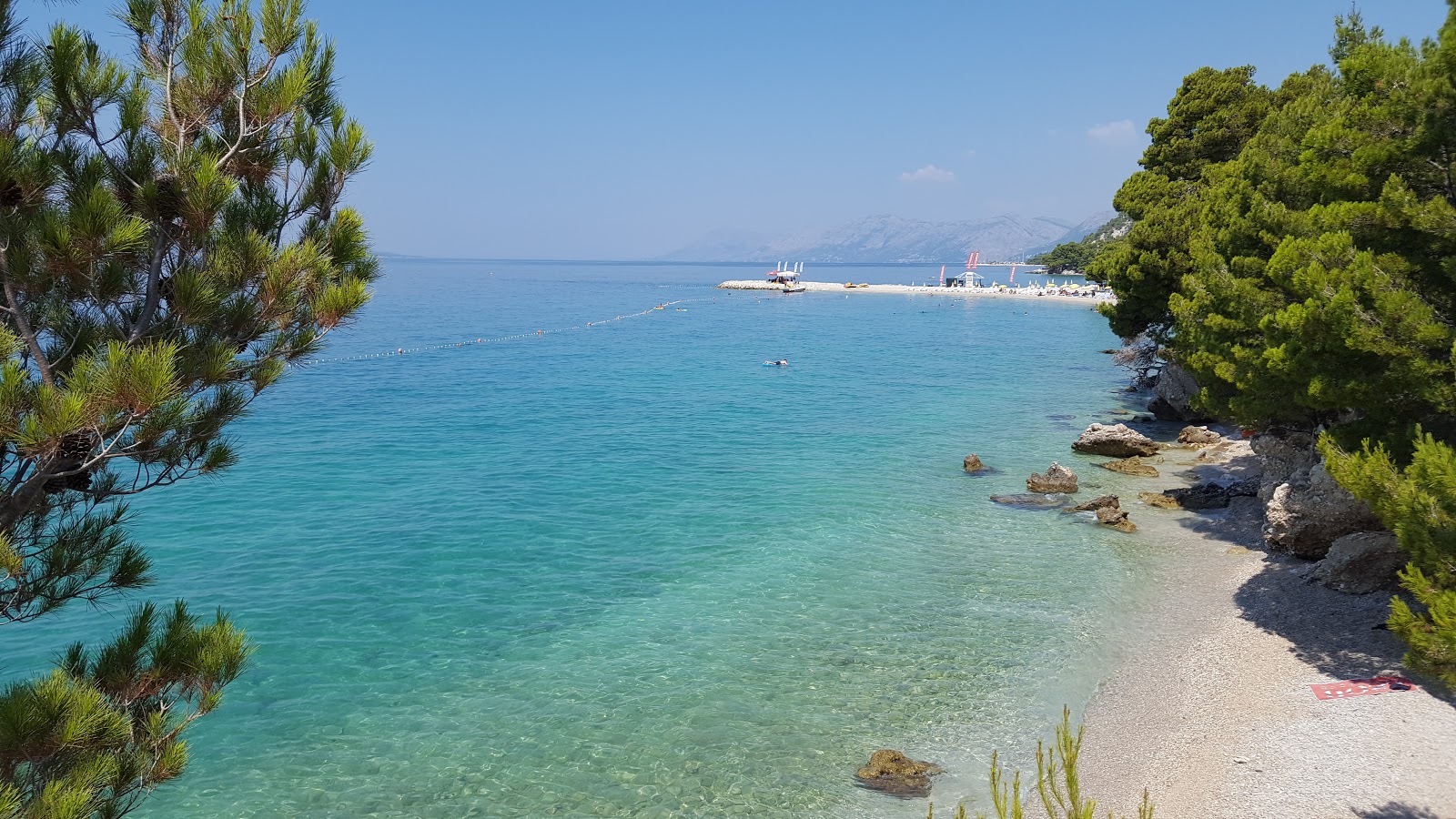 Foto di FKK beach con una superficie del ciottoli neri