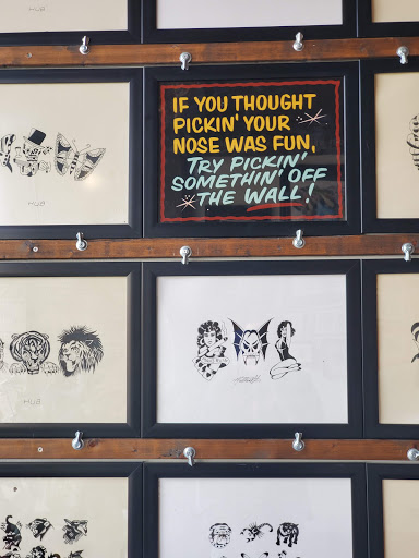 Explore front thigh tattoo ideas for women, creative tattoo ideas in Grand Rapids, available at Sovereign Arms Tattoo