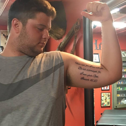 Explore ripped skin tattoo ideas, creative tattoo ideas in Gadsden, available at Old School Ink Electric Tattooing