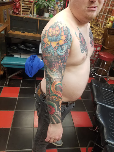 Explore men's back of neck tattoo ideas, creative tattoo ideas in Milwaukee, available at Atomic Tattoos