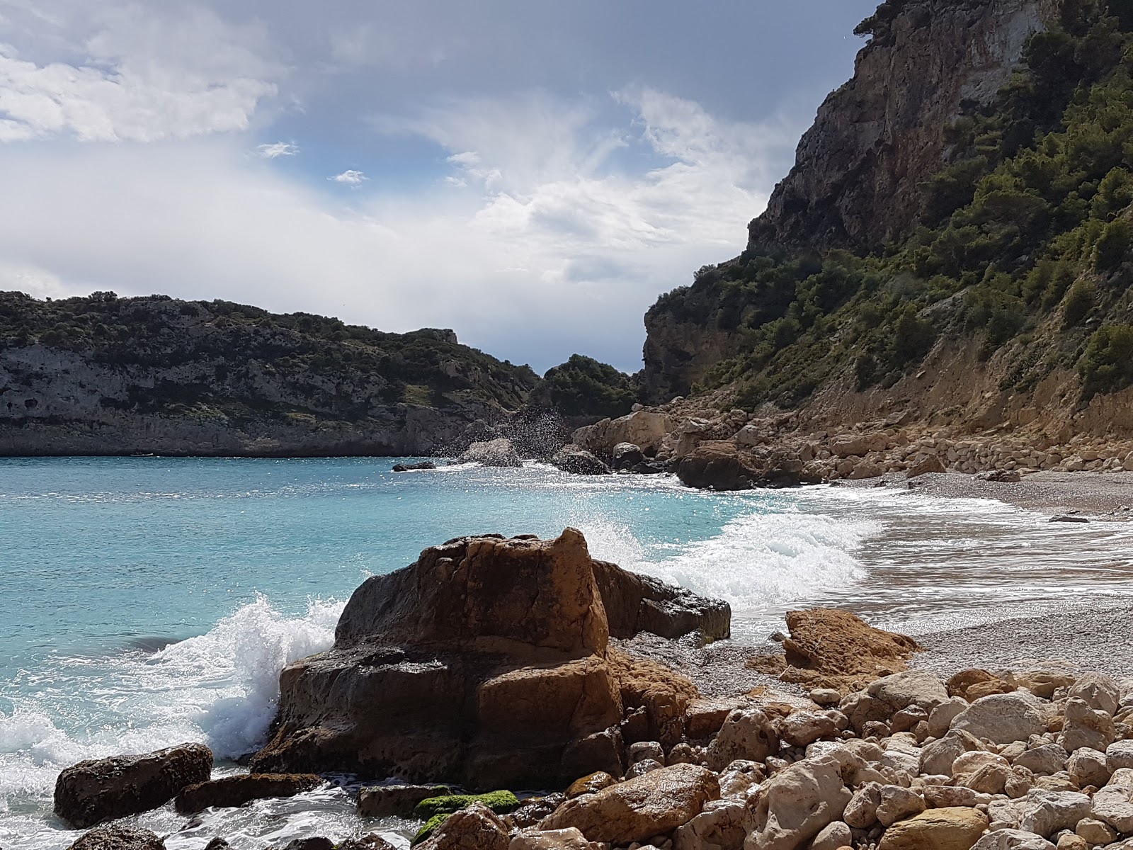 Photo de Cala Ambolo avec baie spacieuse