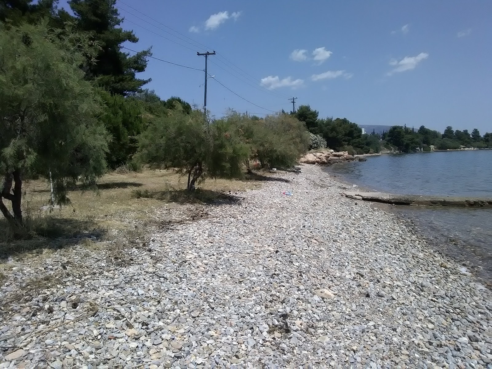 Photo of Magoula beach with gray pebble surface