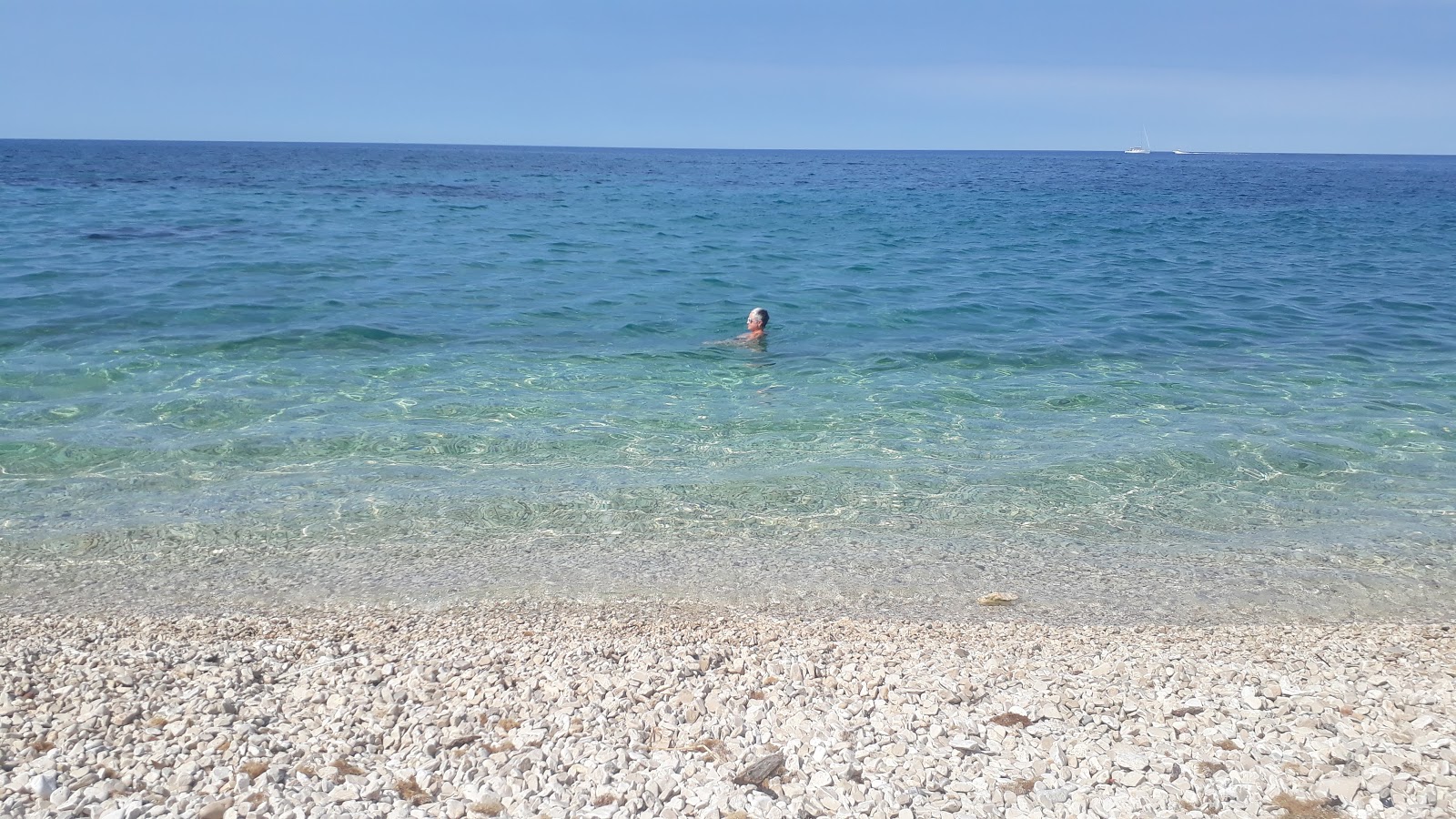 Photo of Umag wild beach with turquoise pure water surface