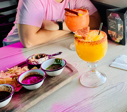 Chips on the house with various dips, and margaritas!