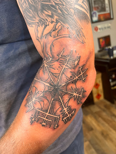 Explore feminine cross tattoo ideas, creative tattoo ideas in Pikeville, available at The Carbon Canary Tattoo Studio