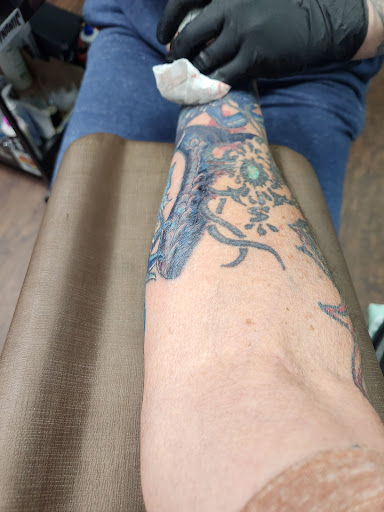 Explore dragonfly flower tattoo ideas, creative tattoo ideas in Broxton, available at Seratonin Tattoo Parlor