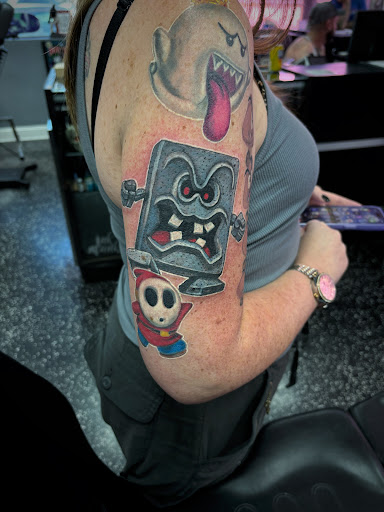 Explore halloween tattoo sleeve ideas, creative tattoo ideas in Fort Myers, available at Loyal 2 The Coil Tattoos & Piercings (Edison Mall Location Entrance F)