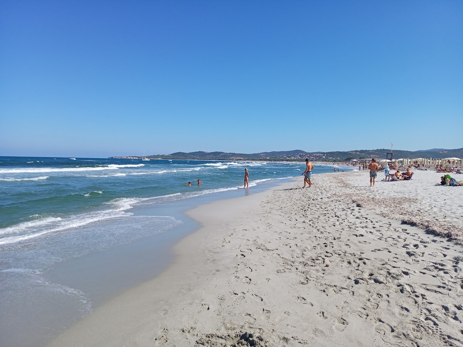 Zdjęcie Plaża Capo Comino z powierzchnią jasny, drobny piasek