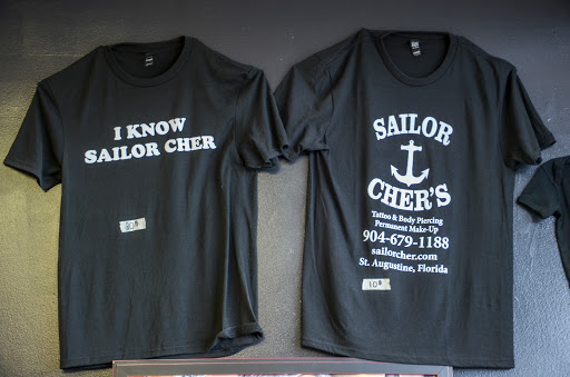 Explore red ink neck tattoo ideas, creative tattoo ideas in Saint Augustine, available at Sailor Chers Tattoo & Body Piercing