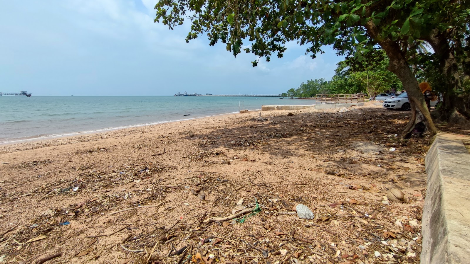 Foto de Bahasa Kapor Beach con arena brillante y rocas superficie