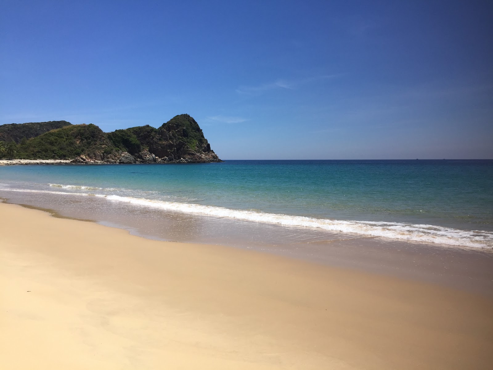 Fotografija Om Beach z svetel fin pesek površino