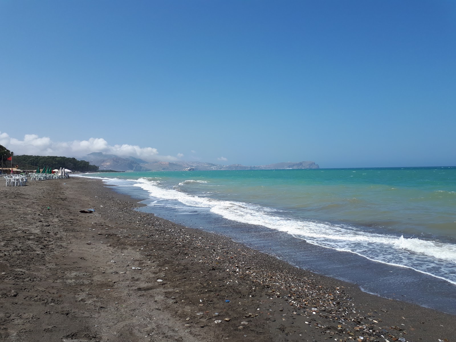 Fotografie cu Playa del Suani cu o suprafață de nisip gri