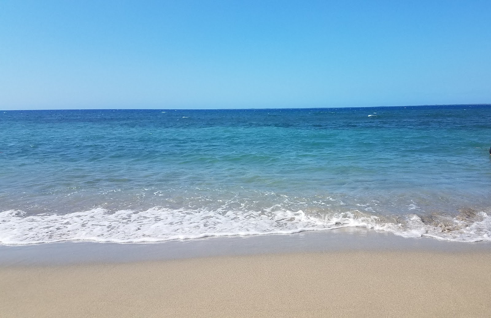 Playa Los Coquitos'in fotoğrafı geniş bir kıyı şeridi ile birlikte
