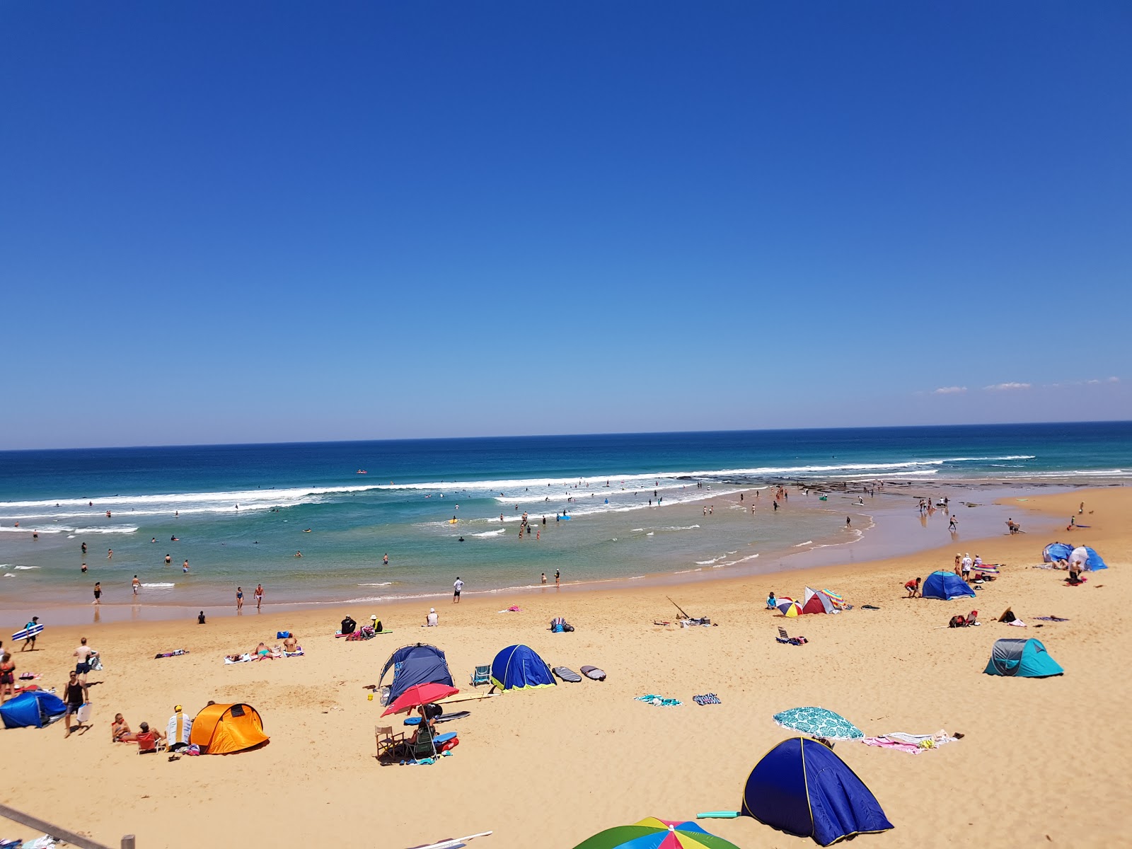 Fotografija Gunnamatta Ocean Beach z svetel pesek površino