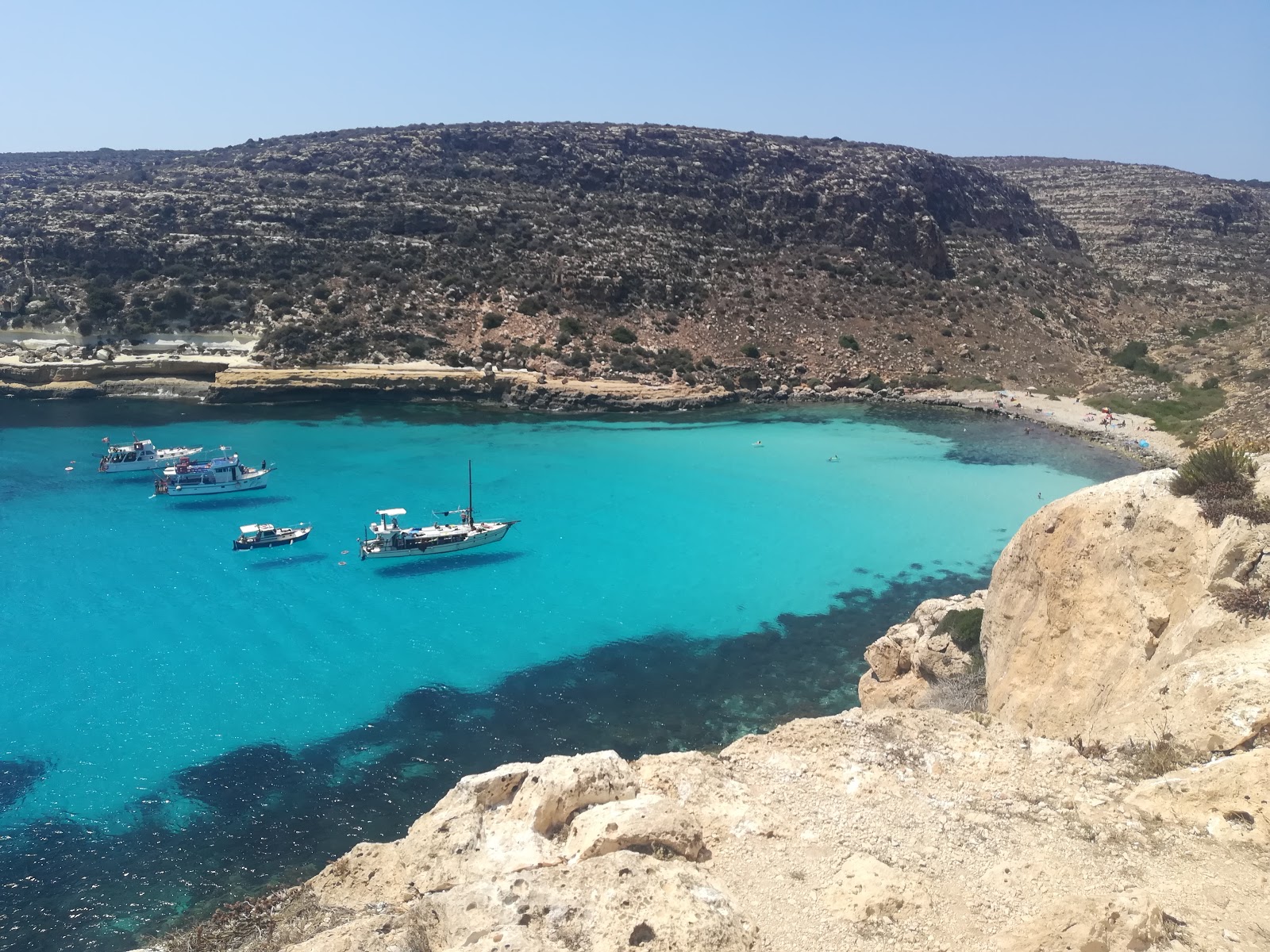 Photo of Cala Pulcino with turquoise pure water surface