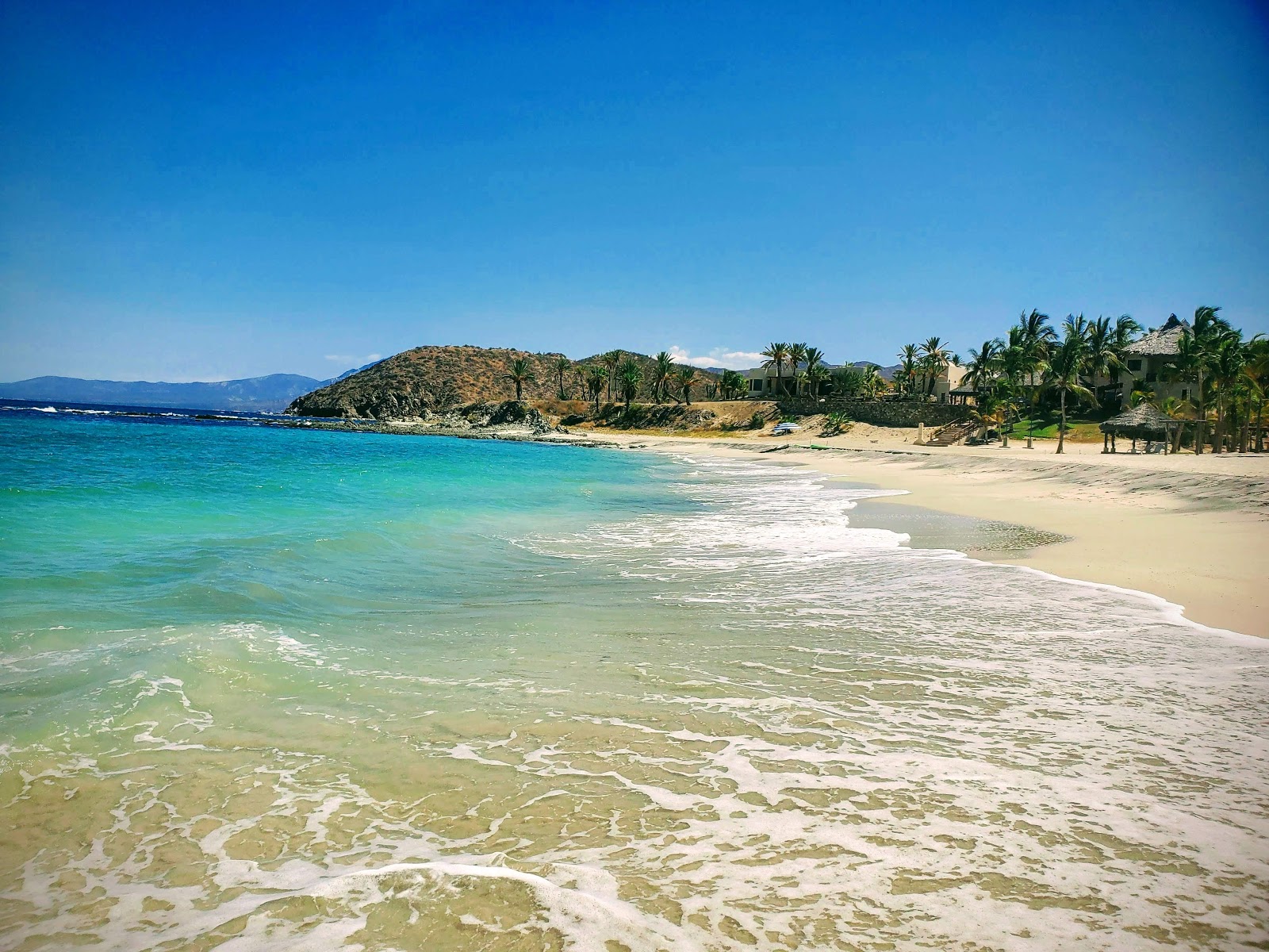 Playa de Los Muertos'in fotoğrafı turkuaz saf su yüzey ile