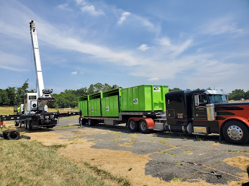  alt='Stansbury provided crane service to unload a new shipment of dumpsters to our Baltimore facility'