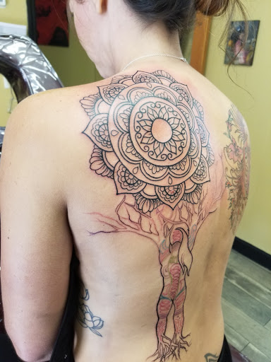 Find between the breast tattoo ideas for your next unique tattoo in Titusville at Exclusive Ink Studio