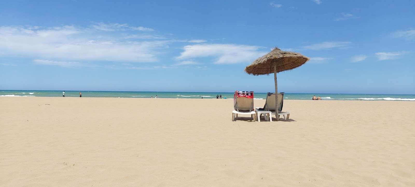 Foto av Melia beach med beige sand yta