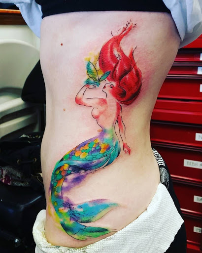 Explore rose thigh tattoo ideas, creative tattoo ideas in Hampton, available at Blue Horseshoe Tattoo and Body Piercing