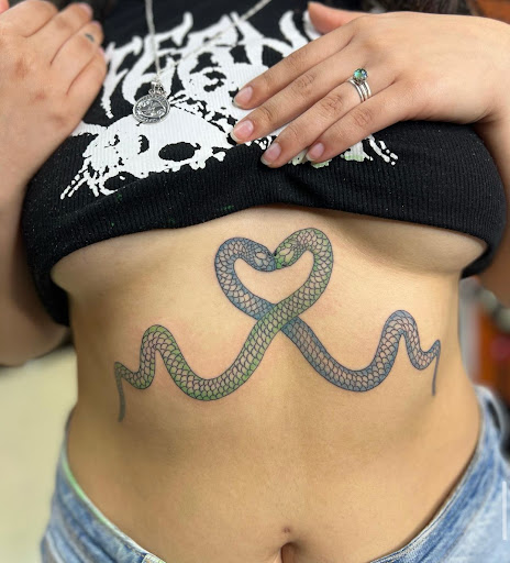 Explore red cardinal tattoo ideas, creative tattoo ideas in Downey, available at Superior Ink Tattoo and Piercings