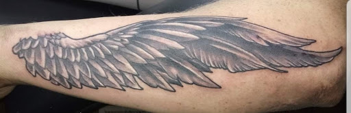 Explore in god we trust tattoo ideas, creative tattoo ideas in Angola, available at Hoodlum Ink