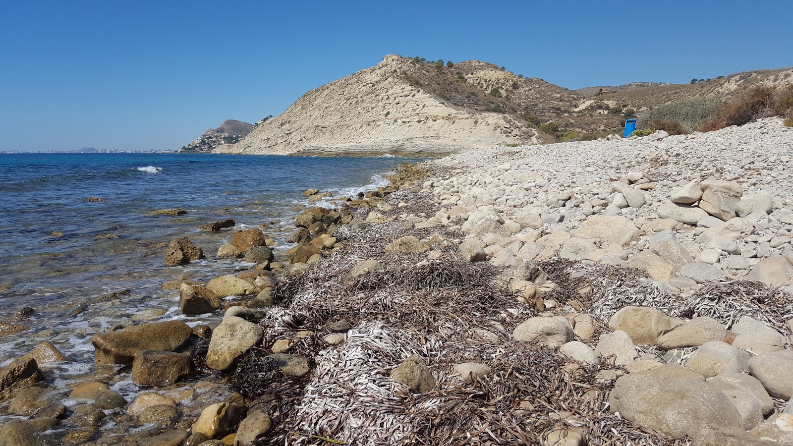 Photo de Playa Carritxal avec l'eau cristalline de surface
