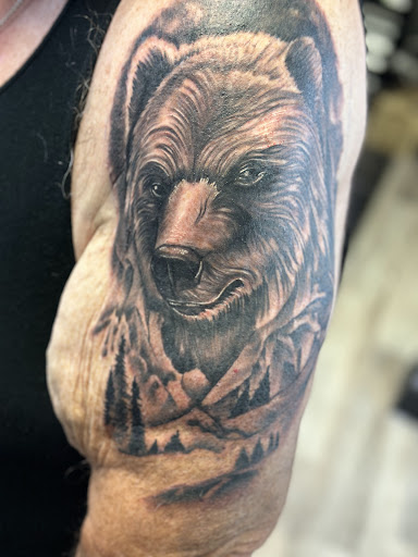 Find lion hand tattoo ideas for men for your next unique tattoo in Port Saint Lucie at Nevermore Tattoo studio