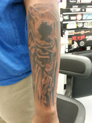 Explore religious elbow tattoo ideas, creative tattoo ideas in Spencer, available at Ink Envy Tattoo And Body Piercing