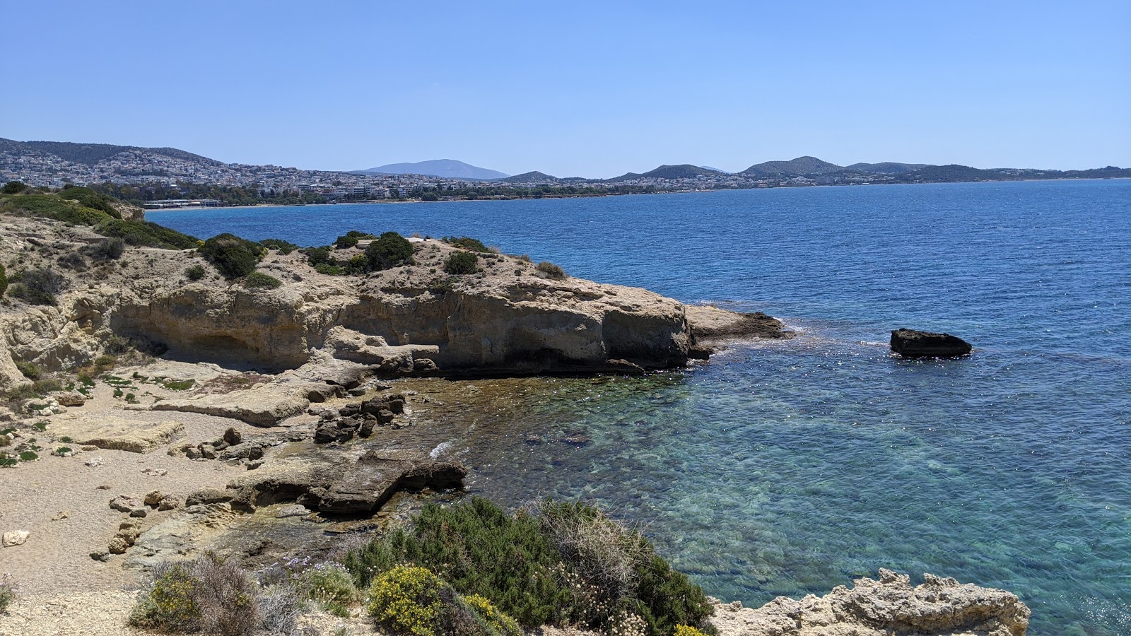 Photo of Pikra beach with brown sand &  rocks surface