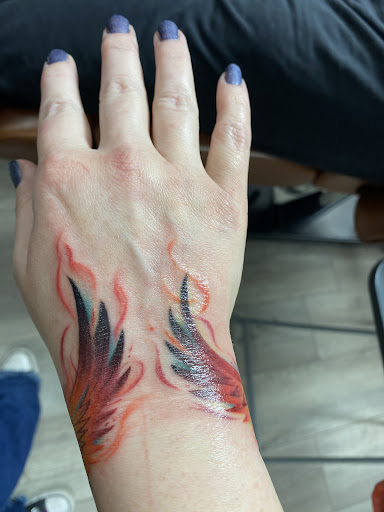 Explore rainbow tattoo ideas, creative tattoo ideas in Youngstown, available at Twisted Metal Custom Body Art