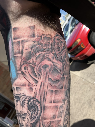 Explore dark skin male black skin tattoo ideas, creative tattoo ideas in Albuquerque, available at Holy Fool Tattoo Club