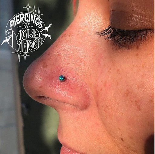 Explore astronaut tattoo ideas, creative tattoo ideas in Oshkosh, available at Piercings by Molly Moon at 920 Tattoo and Piercing