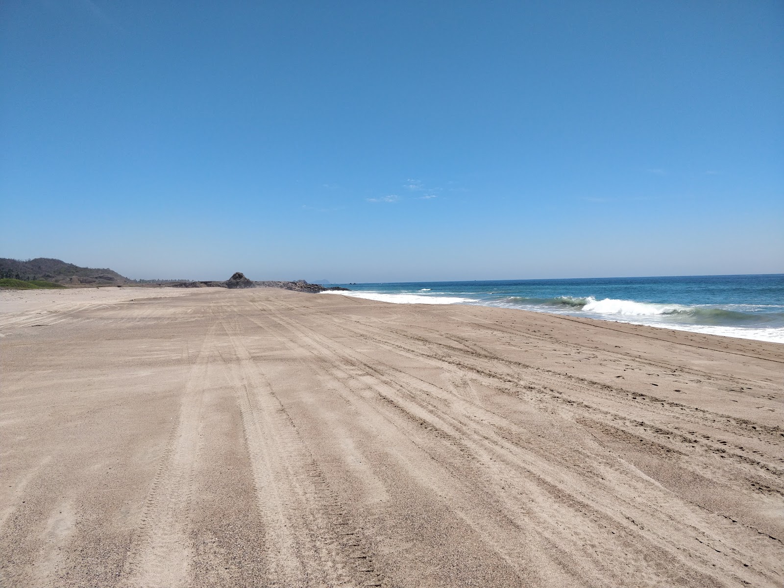 Foto di Tecuan beach con costa lunga e dritta