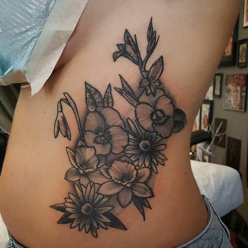 Explore tramp stamp lower back tattoo cover up ideas, creative tattoo ideas in Snohomish, available at Unknown Tattoo Co.