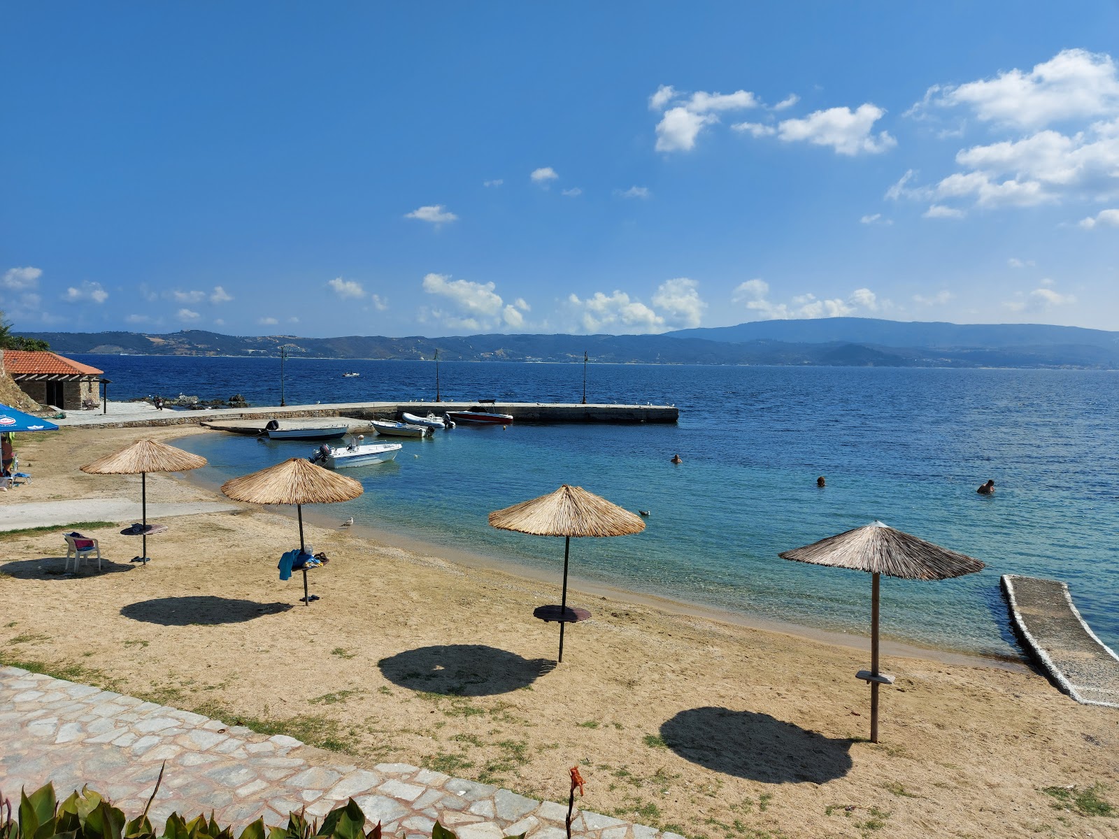 Zdjęcie Tzanis beach z powierzchnią beżowy piasek
