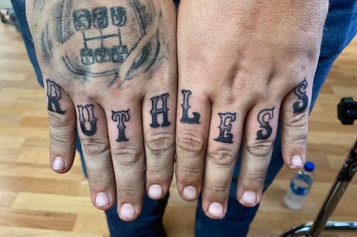 Explore rock n roll tattoo ideas, creative tattoo ideas in Benton, available at Spectrum Tattoo