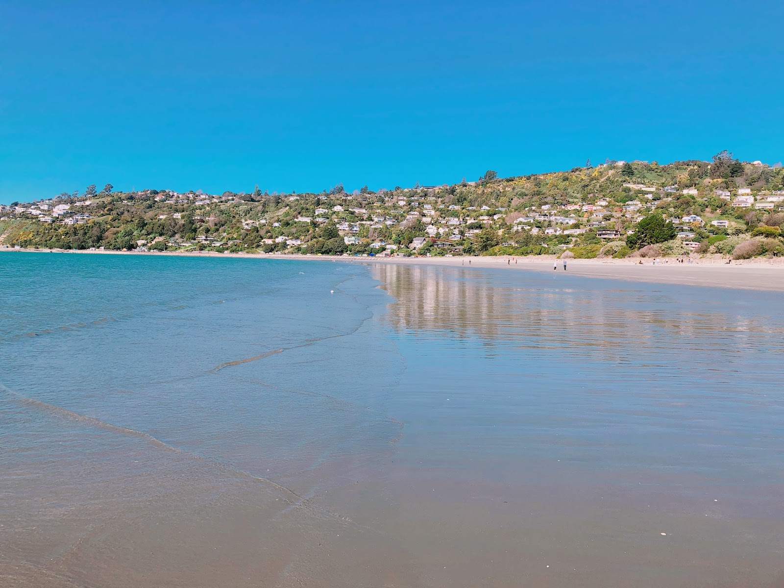 Photo of Tahunanui Beach with turquoise pure water surface