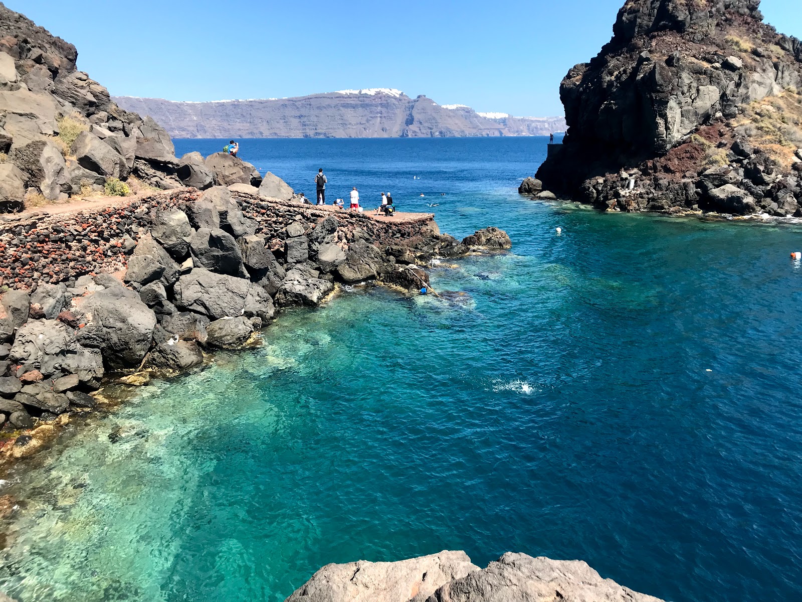 Photo of Ammoudi beach with rocks cover surface