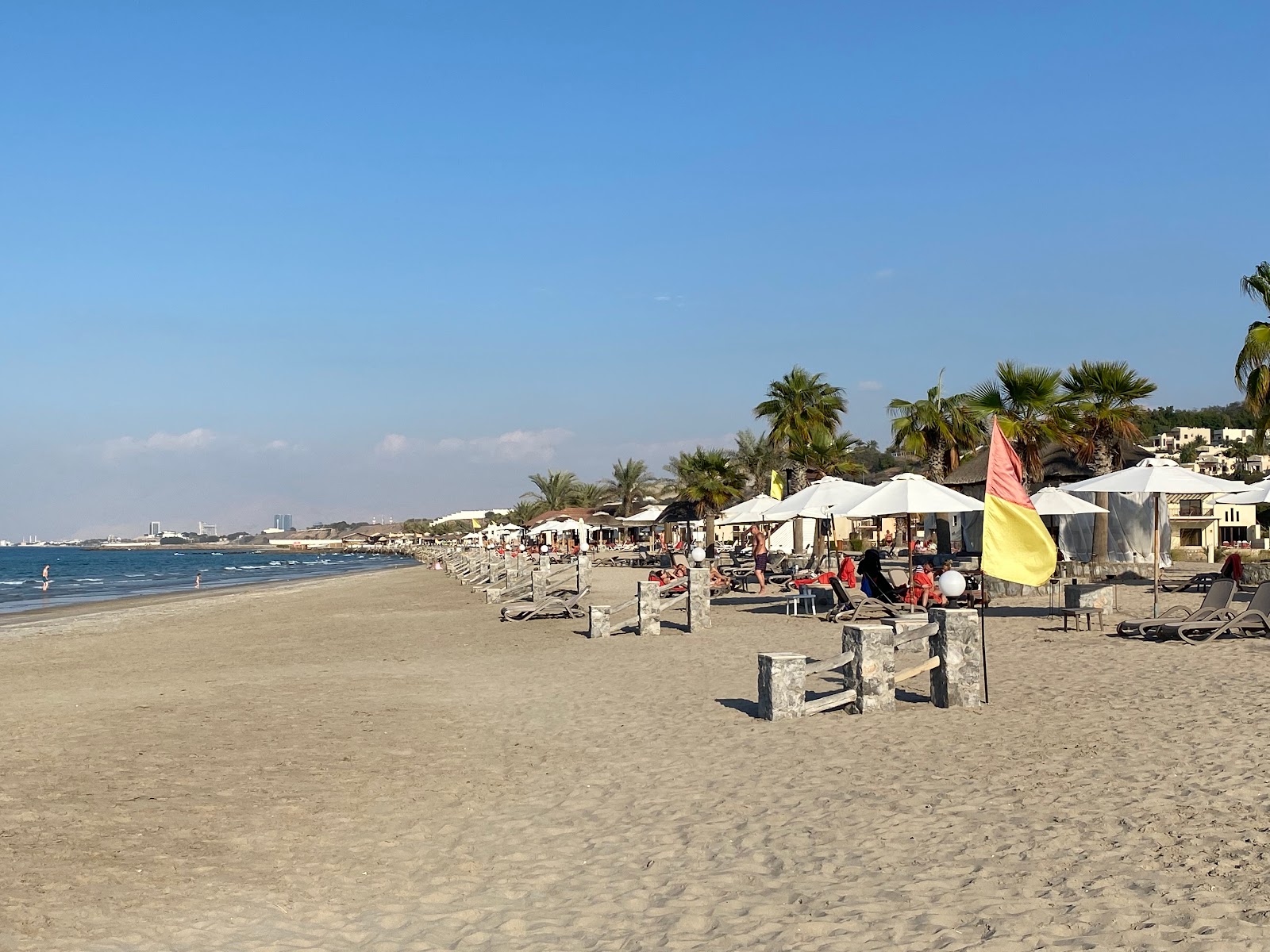 Photo of Cove Rotana resort with bright fine sand surface