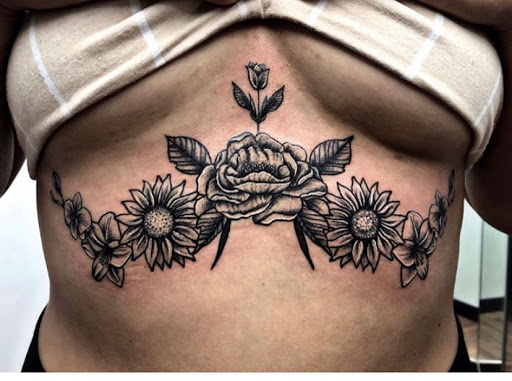 Explore middle of boob tattoo ideas, creative tattoo ideas in Keyport, available at Taboo Tattoos