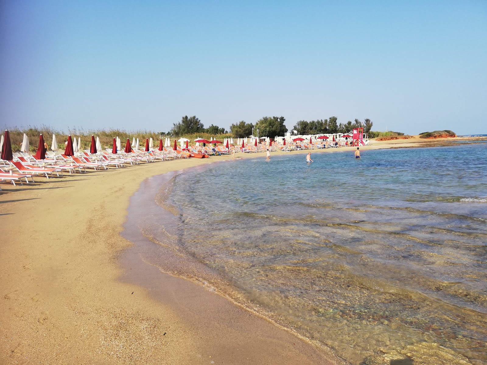 Photo of Torre Santa Sabina beach with blue pure water surface
