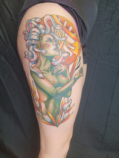 Explore muscle tattoo ideas, creative tattoo ideas in Anniston, available at Lucid Dreams Tattoos and Piercings