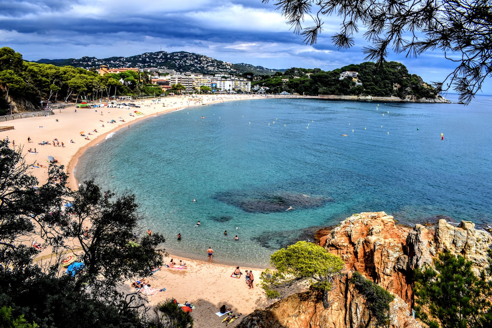 Photo of Platja de Fenals with turquoise pure water surface