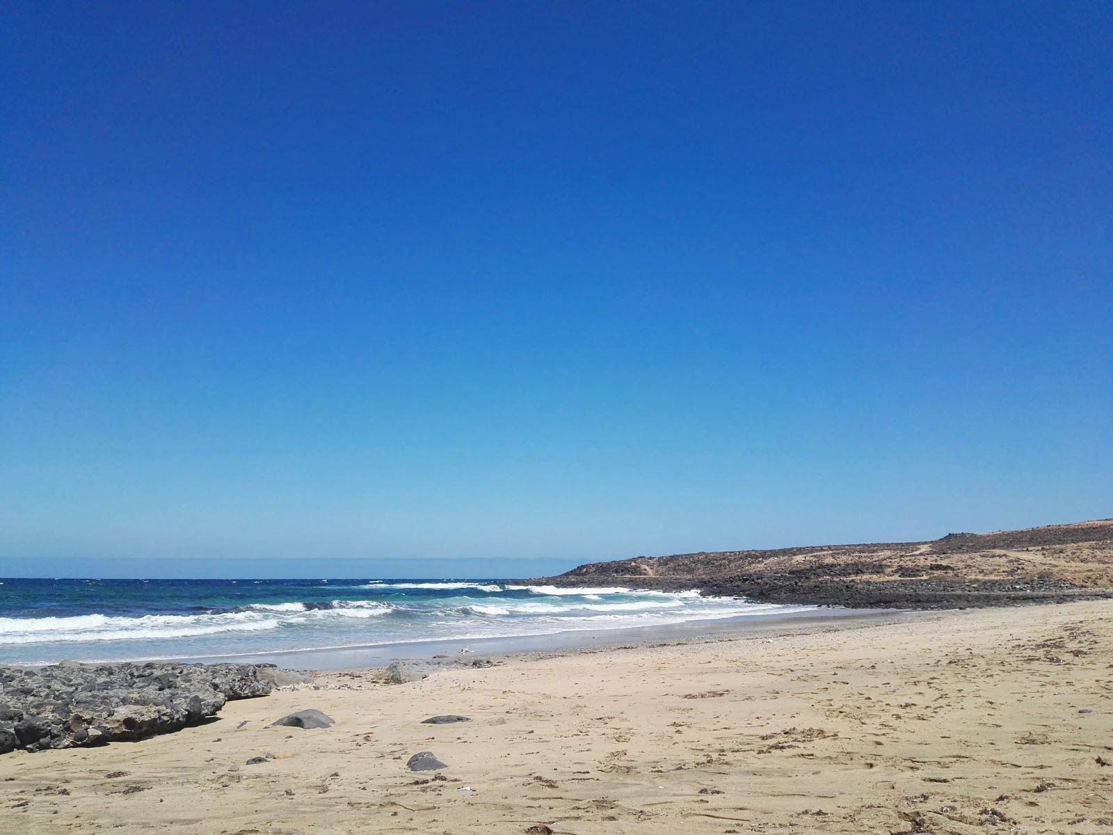 Fotografija Playa Las Caletillas z svetel pesek površino