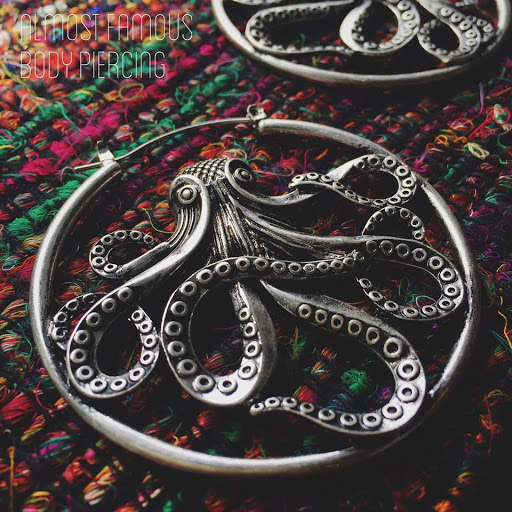 Explore lower belly tattoo ideas, creative tattoo ideas in Saint Cloud, available at Almost Famous Body Piercing