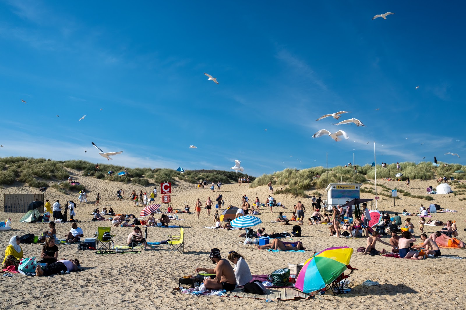 Photo of Camber Sands with blue pure water surface