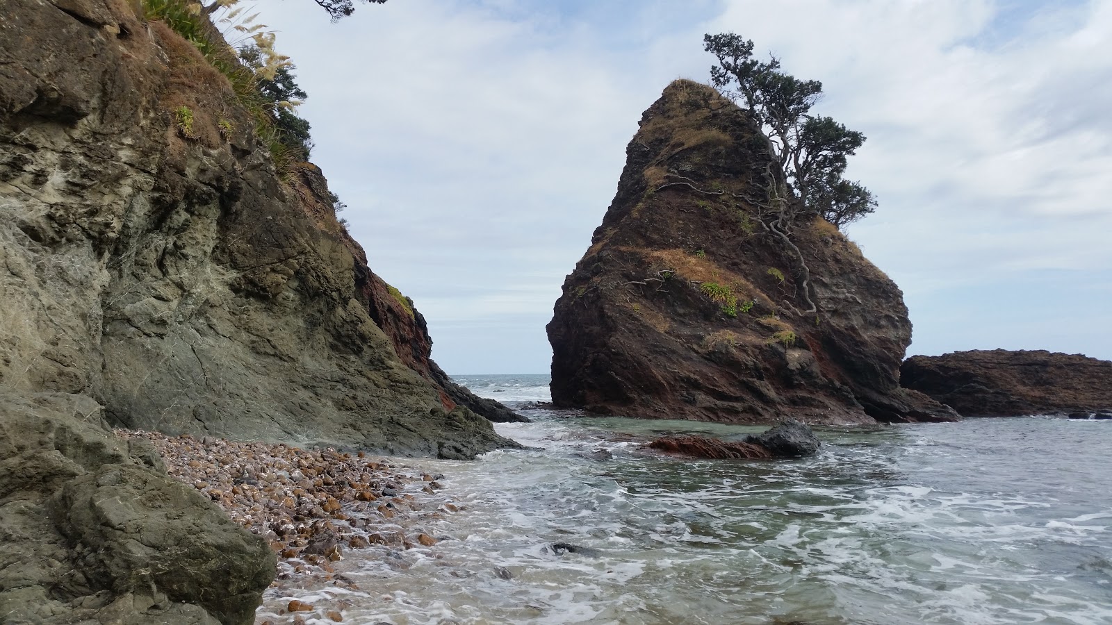 Photo of Pandora Beach backed by cliffs